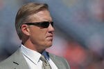 DENVER, CO - SEPTEMBER 18:  John Elway, Executive Vice President of Football Operations for the Denver Broncos, looks on from the bench as the Broncos warm up prior to facing the Cincinnati Bengals at Invesco Field at Mile High on September 18, 2011 in Denver, Colorado.  (Photo by Doug Pensinger/Getty Images)