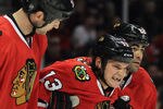 CHICAGO, IL - JANUARY 02:  Daniel Carcillo #13 of the Chicago Blackhawks is helped off of the ice by John Scott #32 and Jamal Mayers #22 after being injured while boarding Tom Gilbert of the Edmonton Oilers in the second period at the United Center on January 2, 2012 in Chicago, Illinois.  (Photo by Jonathan Daniel/Getty Images)