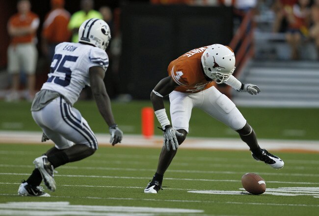 AUSTIN, TX - SEPTEMBER 10:  Wide receiver Darius White #4 of the Texas Longhorns fumbles a second quarter pass as defensive back Corby Eason #25 of the BYU Cougars comes in to tackle on September 10, 2011 at Darrell K. Royal-Texas Memorial Stadium in Austin, Texas.  White recovered his own fumble. (Photo by Erich Schlegel/Getty Images)