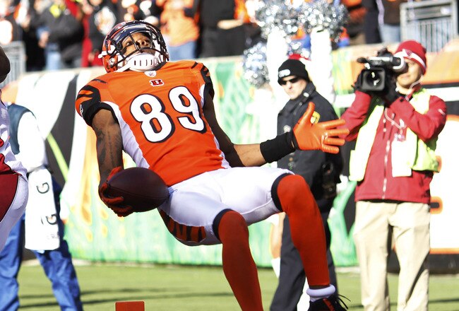 CINCINNATI, OH - DECEMBER 24: Jerome Simpson #89 of the Cincinnati Bengals jumps over Daryl Washington #58 of the Arizona Cardinals for a 19-yard touchdown during first half action at Paul Brown Stadium on December 24, 2011 in Cincinnati, Ohio. (Photo by Joe Robbins/Getty Images)