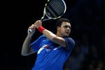 LONDON, ENGLAND - NOVEMBER 27:  Jo-Wilfried Tsonga of France hits the ball during the men's final singles match against Roger Federer of Switzerland during the Barclays ATP World Tour Finals at the O2 Arena on November 27, 2011 in London, England.   (Photo by Julian Finney/Getty Images)
