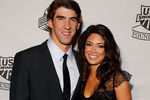 NEW YORK - NOVEMBER 22:  Michael Phelps of the U.S. National Swim Team and Nicole Johnson poses for a photo on the red carpet prior to the 7th Annual Golden Goggle Awards at the Marriott Marquis on November 22, 2010 in New York City.  (Photo by Mike Stobe/Getty Images)