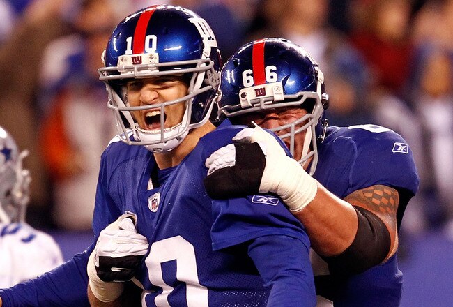 EAST RUTHERFORD, NJ - JANUARY 01:  Eli Manning #10 and  David Diehl #66 of the New York Giants celebrate after a passing touchdown in the fourth quarter at MetLife Stadium on January 1, 2012 in East Rutherford, New Jersey.  (Photo by Jeff Zelevansky/Getty Images)