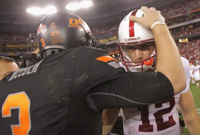 GLENDALE, AZ - JANUARY 02:  Andrew Luck (R) #12 of the Stanford Cardinal congratulates Brandon Weeden #3 of the Oklahoma State Cowboys after Oklahoma State Cowboys won 41-38 in overtime during the Tostitos Fiesta Bowl on January 2, 2012 at University of Phoenix Stadium in Glendale, Arizona.  (Photo by Doug Pensinger/Getty Images)