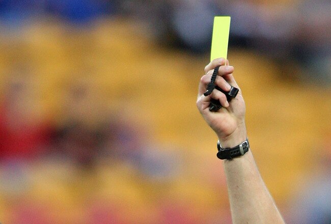 BRISBANE, AUSTRALIA - AUGUST 31:  Referee Peter O'Leary hands out a yellow card to Michael Jedinak of the Mariners during the round three A-League match between the Queensland Roar and the Central Coast Mariners held at Suncorp Stadium on August 31, 2008 in Brisbane, Australia.  (Photo by Bradley Kanaris/Getty Images)