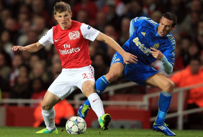 LONDON, ENGLAND - NOVEMBER 01:Andrey Arshavin of Arsenal battles for the ball with Morgan Amalfitano of Olympique de Marseille during the UEFA Champions League Group F match between Arsenal FC v Olympique de Marseille at Emirates Stadium on November 1, 2011 in London, England.  (Photo by David Cannon/Getty Images)