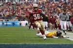 JACKSONVILLE, FL - JANUARY 01:  Running back Jermaine Thomas #38 of the Florida State Seminoles avoids a tackle attempt by linebacker Julian Miller #97 of the West Virginia Mountaineers to score a touchdown in the first quarter during the Konica Minolta Gator Bowl on January 1, 2010 at Jacksonville Municipal Stadium in Jacksonville, Florida. Florida State defeated West Virginia 33-21 in Bobby Bowden's last game as a head coach for the Seminoles.  (Photo by Doug Benc/Getty Images)