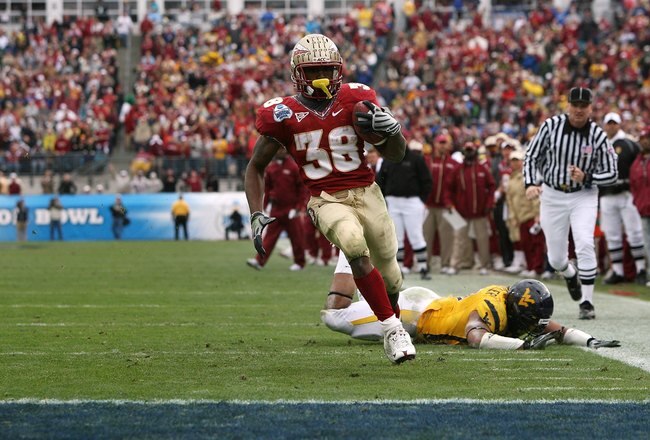 JACKSONVILLE, FL - JANUARY 01:  Running back Jermaine Thomas #38 of the Florida State Seminoles avoids a tackle attempt by linebacker Julian Miller #97 of the West Virginia Mountaineers to score a touchdown in the first quarter during the Konica Minolta Gator Bowl on January 1, 2010 at Jacksonville Municipal Stadium in Jacksonville, Florida. Florida State defeated West Virginia 33-21 in Bobby Bowden's last game as a head coach for the Seminoles.  (Photo by Doug Benc/Getty Images)