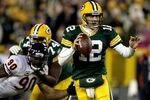 GREEN BAY, WI - DECEMBER 25: Quarterback Aaron Rodgers #12 of the Green Bay Packers is chased out of the pocket while playing the Chicago Bears at Lambeau Field on December 25, 2011 in Green Bay, Wisconsin.  (Photo by Matthew Stockman/Getty Images)