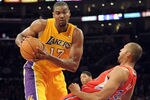 LOS ANGELES, CA - DECEMBER 19:  Andrew Bynum #17 of the Los Angeles Lakers turns as Brian Cook #34 of the Los Angeles Clippers falls during the game at Staples Center on December 19, 2011 in Los Angeles, California. NOTE TO USER: User expressly acknowledges and agrees that, by downloading and/or using this Photograph, user is consenting to the terms and conditions of the Getty Images License Agreement. Mandatory Copyright Notice: Copyright 2011 NBAE  (Photo by Harry How/Getty Images)
