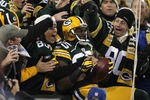 GREEN BAY, WI - NOVEMBER 14:  Greg Jennings #85 of the Green Bay Packers celebrates with fans after he scored on a 24-yard touchdown reception in the first quarter against the Minnesota Vikings at Lambeau Field on November 14, 2011 in Green Bay, Wisconsin.  (Photo by Jonathan Daniel/Getty Images)