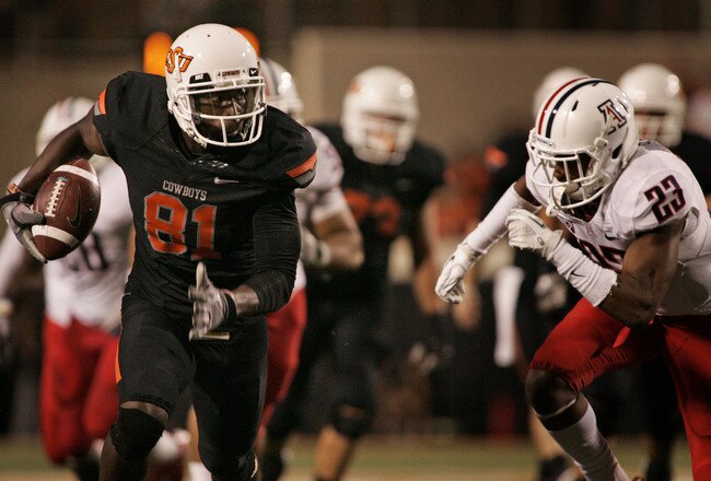 STILLWATER, OK - SEPTEMBER 8:  Wide receiver Justin Blackmon #81 of the Oklahoma State Cowboys slips past safety Mark Watley #23 of the Arizona Wildcats during the second half on September 8, 2011 at Boone Pickens Stadium in Stillwater, Oklahoma.  Oklahoma State defeated Arizona 37-14.  (Photo by Brett Deering/Getty Images)