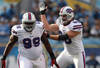SAN DIEGO, CA - DECEMBER 11:  Quarterback Philip Rivers #17 of the San Diego Chargers is sacked by Marcell Dareus #99 and Chris Kelsay #90 of the Buffalo Bills during their NFL Game on December 11, 2011 at Qualcomm Stadium in San Diego, California. (Photo by Donald Miralle/Getty Images)