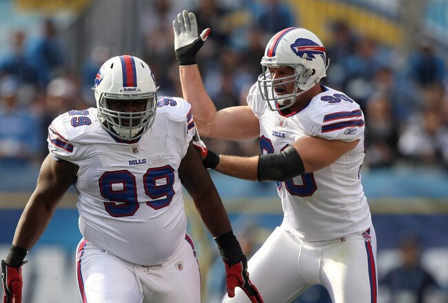 SAN DIEGO, CA - DECEMBER 11:  Quarterback Philip Rivers #17 of the San Diego Chargers is sacked by Marcell Dareus #99 and Chris Kelsay #90 of the Buffalo Bills during their NFL Game on December 11, 2011 at Qualcomm Stadium in San Diego, California. (Photo by Donald Miralle/Getty Images)