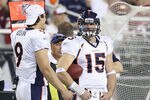 GLENDALE, AZ - DECEMBER 12:  Quarterbacks Brady Quinn #9 and Tim Tebow #15 of the Denver Broncos stand on the sideline during the NFL game against the Arizona Cardinals at the University of Phoenix Stadium on December 12, 2010 in Glendale, Arizona.   The Cardinals defeated the Broncos 43-13.  (Photo by Christian Petersen/Getty Images)