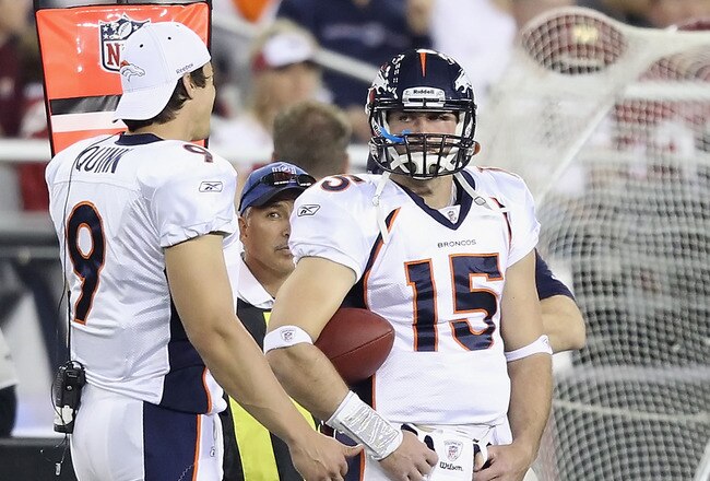 GLENDALE, AZ - DECEMBER 12:  Quarterbacks Brady Quinn #9 and Tim Tebow #15 of the Denver Broncos stand on the sideline during the NFL game against the Arizona Cardinals at the University of Phoenix Stadium on December 12, 2010 in Glendale, Arizona.   The Cardinals defeated the Broncos 43-13.  (Photo by Christian Petersen/Getty Images)