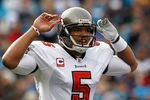CHARLOTTE, NC - DECEMBER 24:  Josh Freeman #5 of the Tampa Bay Buccaneers calls a play during their game against the Carolina Panthers at Bank of America Stadium on December 24, 2011 in Charlotte, North Carolina.  (Photo by Streeter Lecka/Getty Images)