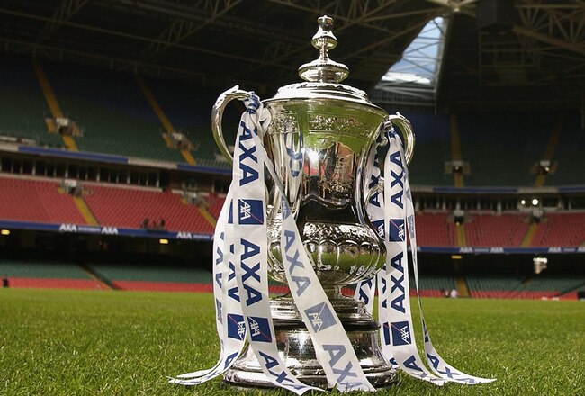 CARDIFF - MAY 3:  The FA Cup trophy sits proudly on the pitch as a groundsman makes final preparations for the final of the FA Cup during the AXA FA Cup Preview held at The Millennium Stadium in Cardiff, Wales on May 3, 2002. (Photo by: Stu Forster/Getty Images)