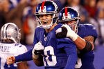 EAST RUTHERFORD, NJ - JANUARY 01:  Eli Manning #10 and  David Diehl #66 of the New York Giants celebrate after a passing touchdown in the fourth quarter at MetLife Stadium on January 1, 2012 in East Rutherford, New Jersey.  (Photo by Jeff Zelevansky/Getty Images)