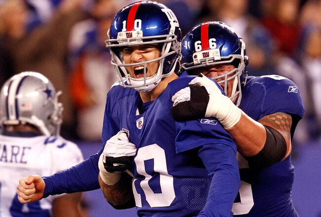 EAST RUTHERFORD, NJ - JANUARY 01:  Eli Manning #10 and  David Diehl #66 of the New York Giants celebrate after a passing touchdown in the fourth quarter at MetLife Stadium on January 1, 2012 in East Rutherford, New Jersey.  (Photo by Jeff Zelevansky/Getty Images)