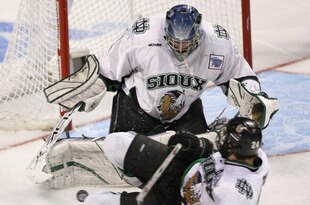 Chris Porter #24 of North Dakota dives to block a shot in front of goalie Jordan Parise against Boston College during 3rd-period action in the semi-finals of the NCAA frozen four at the Bradley Center in Milwaukee, Wisconsin on April 6, 2006.  Boston College won 6-5 to advance to the National Championship. (Photo by G. N. Lowrance/Getty Images)