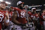 ARLINGTON, TX - JANUARY 06:  DeQuinta Jones #92 of the Arkansas Razorbacks celebrates the Cotton Bowl trophy after defeating the Kansas State Wildcats at Cowboys Stadium on January 6, 2012 in Arlington, Texas.  (Photo by Ronald Martinez/Getty Images)