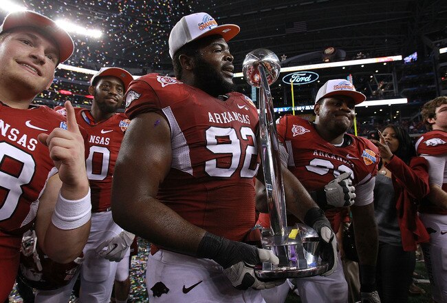 ARLINGTON, TX - JANUARY 06:  DeQuinta Jones #92 of the Arkansas Razorbacks celebrates the Cotton Bowl trophy after defeating the Kansas State Wildcats at Cowboys Stadium on January 6, 2012 in Arlington, Texas.  (Photo by Ronald Martinez/Getty Images)