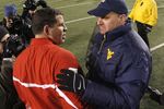 MORGANTOWN, WV - DECEMBER 2:  Rich Rodriguez head coach of the Virginia Mountaineers shakes the hand of Greg Schiano head coach of the Rutgers Scarlet Knights after a 41-39 West Virginia win at Milan Puskar Stadium December 2, 2006 in Morgantown, West Virginia.  (Photo by Gregory Shamus/Getty Images)