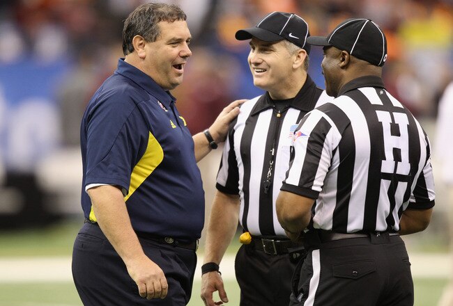 NEW ORLEANS, LA - JANUARY 03:  Head coach Brady Hoke of the Michigan Wolverines talks with 2 referees prior to coaching against the Virginia Tech Hokies during the Allstate Sugar Bowl at Mercedes-Benz Superdome on January 3, 2012 in New Orleans, Louisiana.  (Photo by Matthew Stockman/Getty Images)