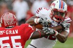 HOUSTON, TX - NOVEMBER 19: Running back Jared Williams #22 of the Southern Methodist University Mustangs is tackled by linebacker Marcus McGraw #55 of the Houston Cougars on November 19, 2011 at Robertson Stadium in Houston, Texas. (Photo by Thomas B. Shea/Getty Images)