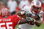 HOUSTON, TX - NOVEMBER 19: Running back Jared Williams #22 of the Southern Methodist University Mustangs is tackled by linebacker Marcus McGraw #55 of the Houston Cougars on November 19, 2011 at Robertson Stadium in Houston, Texas. (Photo by Thomas B. Shea/Getty Images)
