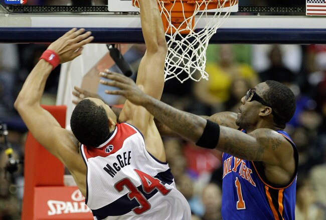 WASHINGTON, DC - JANUARY 06: JaVale McGee #34 of the Washington Wizards puts up a shot over the defense of Amare Stoudemire #1 of the New York Knicks at Verizon Center on January 6, 2012 in Washington, DC.  NOTE TO USER: User expressly acknowledges and agrees that, by downloading and or using this photograph, User is consenting to the terms and conditions of the Getty Images License Agreement.  (Photo by Rob Carr/Getty Images)