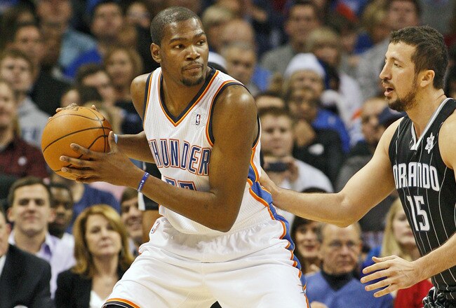 OKLAHOMA CITY, OK - DECEMBER 25:  Kevin Durant #35 of the Oklahoma City Thunder looks to drive on Hedo Turkoglu #15 of the Orlando Magic during the NBA season opening game December 25, 2011 at the Chesapeake Energy Arena in Oklahoma City, Oklahoma.  Oklahoma City led Orlando at the half. NOTE TO USER: User expressly acknowledges and agrees that, by downloading and or using this Photograph, user is consenting to the terms and conditions of the Getty Images License Agreement.  (Photo by Brett Deering/Getty Images)