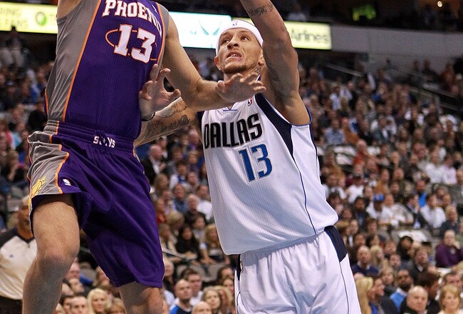 DALLAS, TX - JANUARY 04:  Steve Nash #13 of the Phoenix Suns takes a shot against Delonte West #13 of the Dallas Mavericks at American Airlines Center on January 4, 2012 in Dallas, Texas.  NOTE TO USER: User expressly acknowledges and agrees that, by downloading and/or using this Photograph, user is consenting to the terms and conditions of the Getty Images License Agreement.  (Photo by Ronald Martinez/Getty Images)