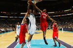 NEW ORLEANS, LA - JANUARY 04:  Carl Landry #24 of the New Orleanss Hornets shoots the ball over Evan Turner #12 of the Philadelphia 76ers at New Orleans Arena on January 4, 2012 in New Orleans, Louisiana.  NOTE TO USER: User expressly acknowledges and agrees that, by downloading and or using this photograph, User is consenting to the terms and conditions of the Getty Images License Agreement.  (Photo by Chris Graythen/Getty Images)