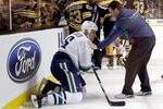 BOSTON, MA - JANUARY 07:  Sami Salo #6 of the Vancouver Canucks is helped off the ice after he was hit by Brad Marchand #63 of the Boston Bruins on January 7, 2012 at TD Garden in Boston, Massachusetts.  (Photo by Elsa/Getty Images)