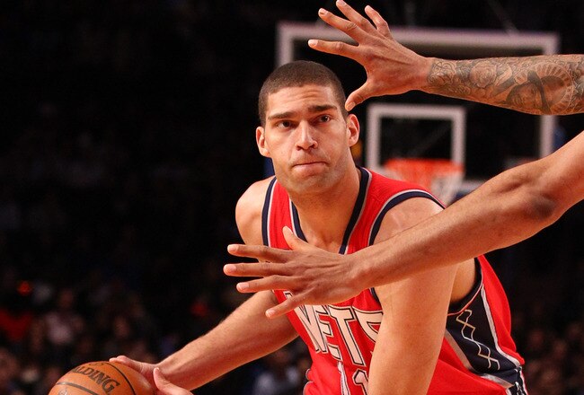 NEW YORK, NY - DECEMBER 21:  Brook Lopez #11 of the New Jersey Nets looks to pass against the New York Knicks during their pre season game  at Madison Square Garden on December 21, 2011 in New York City. NOTE TO USER: User expressly acknowledges and agrees that, by downloading and or using this photograph, User is consenting to the terms and conditions of the Getty Images License Agreement. (Photo by Al Bello/Getty Images)