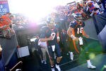DENVER, CO - DECEMBER 18: Quarterbacks Tim Tebow #15 and Brady Quinn #9 of the Denver Broncos take the field during warm ups before playing the New England Patriots at Sports Authority Field at Mile High on December 18, 2011 in Denver, Colorado. (Photo by Patrick Smith/Getty Images)