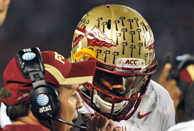 ORLANDO, FL - DECEMBER 29: Coach Jimbo Fisher gives a play to quarterback E. J. Manuel #3 of the Florida State Seminoles during play against the Notre Dame Fighting Irish in the Champs Sports Bowl December 29, 2011 at the Florida Citrus Bowl in Orlando, Florida.  FSU won 18 - 14. (Photo by Al Messerschmidt/Getty Images)