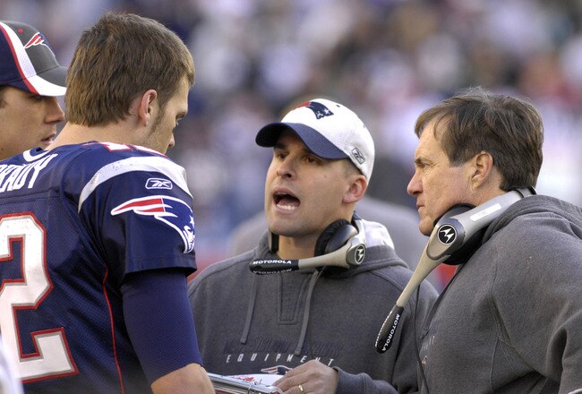 New England Patriots coach Bill Belichick (right) and Josh McDaniels (center) with quarterback Tom Brady   against the New York Jets in  an NFL wild card playoff game Jan. 7, 2007 in Foxborough.  The Pats won 37 - 16. (Photo by Al Messerschmidt/Getty Images)