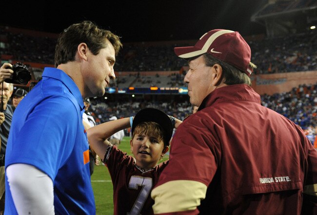 GAINESVILLE, FL - NOVEMBER 26:  Coach Jimbo Fisher of the Florida State Seminoles and his son Trey greet coach Will Muschamp of the Florida Gators at midfield before play November 26, 2011 at Ben Hill Griffin Stadium in Gainesville, Florida.  (Photo by Al Messerschmidt/Getty Images)