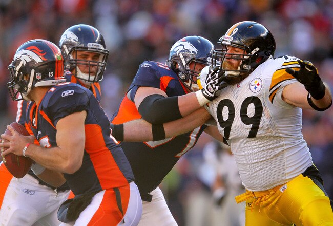 DENVER, CO - JANUARY 08:  Tim Tebow #15 of the Denver Broncos looks to throw the ball against the Pittsburgh Steelers during the AFC Wild Card Playoff game at Sports Authority Field at Mile High on January 8, 2012 in Denver, Colorado.  (Photo by Doug Pensinger/Getty Images)