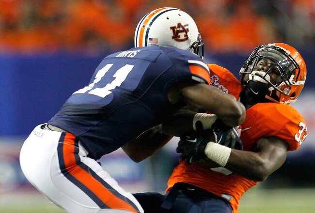 ATLANTA, GA - DECEMBER 31:  Chris Davis #11 of the Auburn Tigers forces a fumble into a turnover by Perry Jones #33 of the Virginia Cavaliers during the 2011 Chick Fil-A Bowl at Georgia Dome on December 31, 2011 in Atlanta, Georgia.  (Photo by Kevin C. Cox/Getty Images)