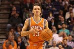 PHOENIX, AZ - DECEMBER 26:  Steve Nash #13 of the Phoenix Suns handles the ball during the season openning NBA game against the New Orleans Hornets at US Airways Center on December 26, 2011 in Phoenix, Arizona.  The Hornets defeated the Suns 85-84. NOTE TO USER: User expressly acknowledges and agrees that, by downloading and or using this photograph, User is consenting to the terms and conditions of the Getty Images License Agreement.  (Photo by Christian Petersen/Getty Images)