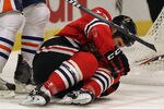 CHICAGO, IL - JANUARY 02:  Daniel Carcillo #13 of the Chicago Blackhawks lays on the ice after being injured while boarding Tom Gilbert of the Edmonton Oilers in the second period at the United Center on January 2, 2012 in Chicago, Illinois. The Oilers defeated the Blackhawks 4-3.  (Photo by Jonathan Daniel/Getty Images)