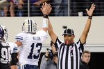 ARLINGTON, TX - OCTOBER 28:  Riley Nelson #13 of the BYU Cougars gives the referee a high five after scoring during a game against the TCU Horned Frogs at Cowboys Stadium on October 28, 2011 in Arlington, Texas. The TCU Horned Frogs defeated the BYU Cougars 38-28.  (Photo by Sarah Glenn/Getty Images)