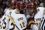 ST. PAUL, MN - APRIL 07:  Jack Connolly #12 of the Minnesota Duluth Bulldogs is congratulated by teammate J.T. Brown #23 after Connolly scored in the second period against the Notre Dame Fighting Irish during semifinals of the 2011 NCAA Men's Frozen Four on April 7, 2011 at the Xcel Energy Center in St. Paul, Minnesota.  (Photo by Elsa/Getty Images)