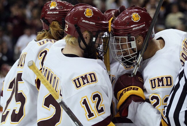 ST. PAUL, MN - APRIL 07:  Jack Connolly #12 of the Minnesota Duluth Bulldogs is congratulated by teammate J.T. Brown #23 after Connolly scored in the second period against the Notre Dame Fighting Irish during semifinals of the 2011 NCAA Men's Frozen Four on April 7, 2011 at the Xcel Energy Center in St. Paul, Minnesota.  (Photo by Elsa/Getty Images)