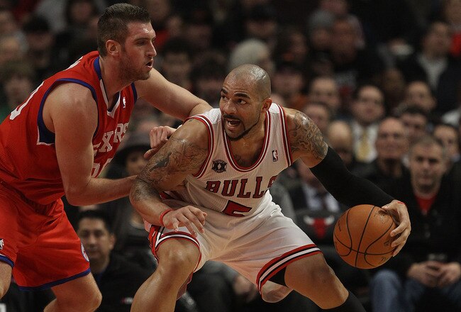 CHICAGO, IL - DECEMBER 21: Carlos Boozer #5 of the Chicago Bulls moves against Spencer Hawes #00 of the Philadelphia 76ers at the United Center on December 21, 2010 in Chicago, Illinois. The Bulls defeated the 76ers 121-76. NOTE TO USER: User expressly acknowledges and agrees that, by downloading and/or using this photograph, User is consenting to the terms and conditions of the Getty Images License Agreement. (Photo by Jonathan Daniel/Getty Images)