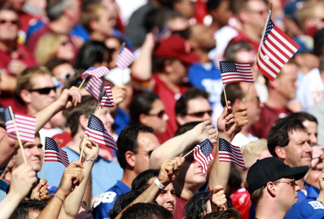 LANDOVER, MD - SEPTEMBER 11:  Fans waves American flags before the start of the game between the Washington Redskins and the New York Giants at FedExField on September 11, 2011 in Landover, Maryland.  (Photo by Ronald Martinez/Getty Images)
